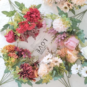 Artificial rose mixed flower bouquets in coordinated colorways displayed in a flat lay