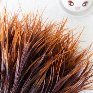 Close-up of autumn red artificial grass foliage