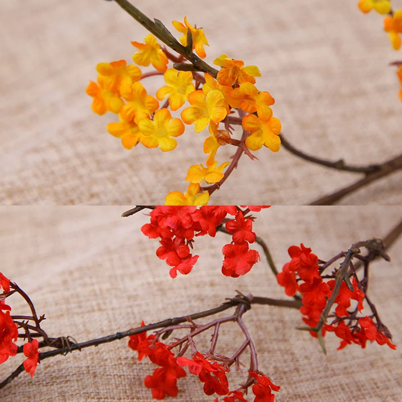 Close-up of orange red detail for artificial small blossom branch