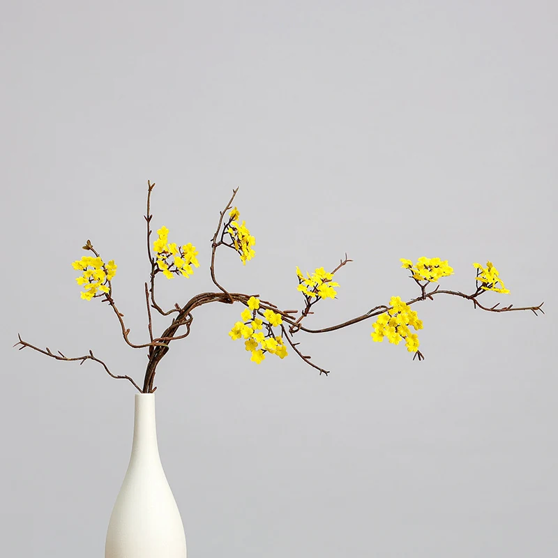 Yellow artificial small blossom branch