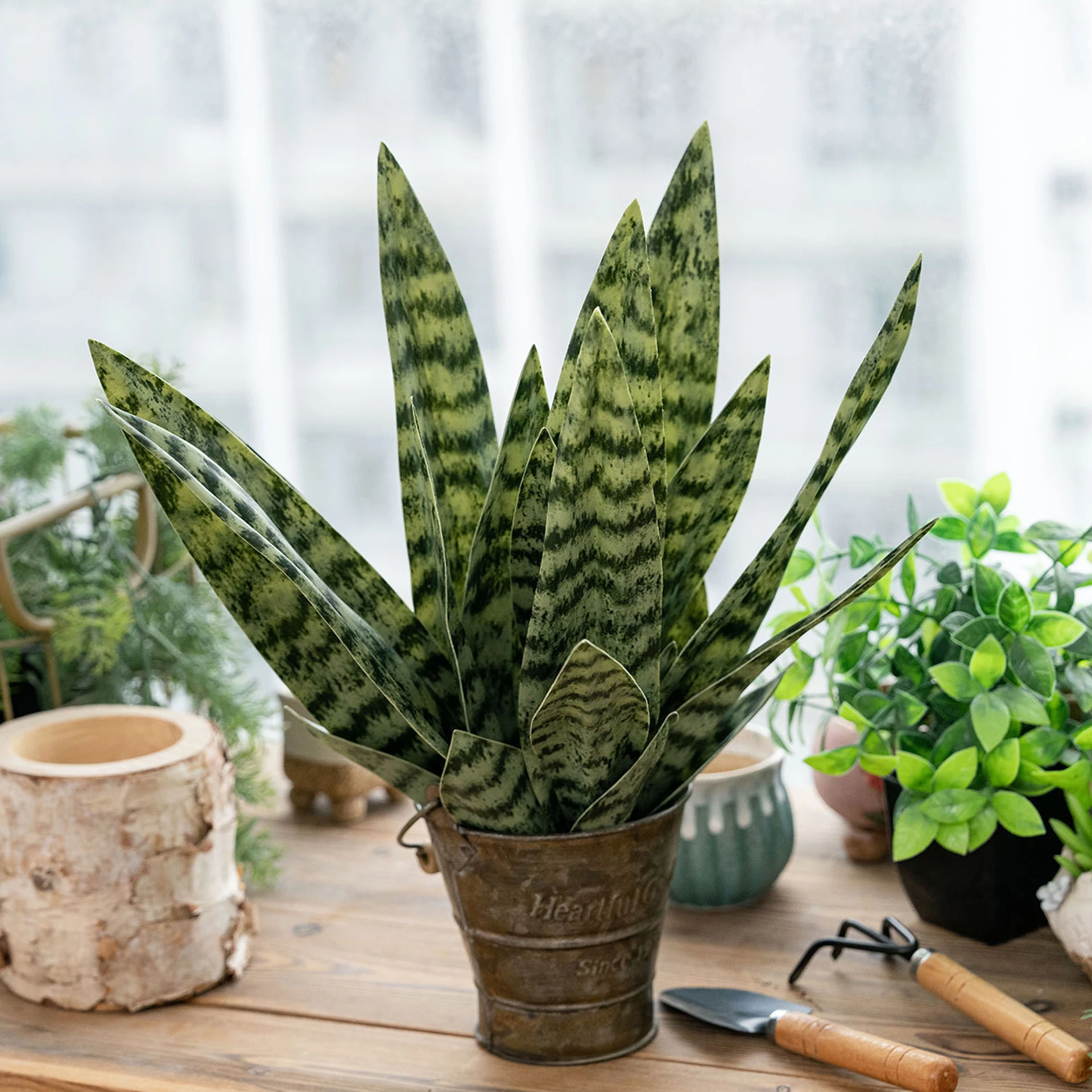 Application display of mottled green artificial snake plant leaf insert