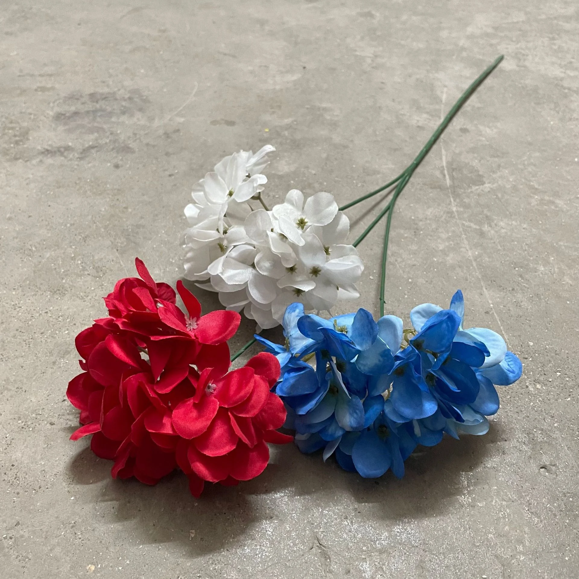 Close-up of red, blue and white artificial hydrangea flower heads