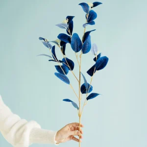 Handheld view of blue artificial velvet eucalyptus spray