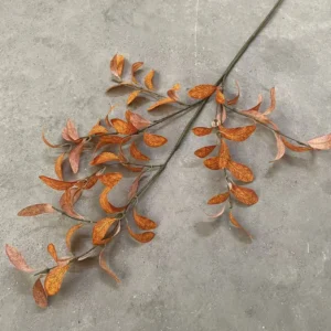 Angled view of burnt orange artificial eucalyptus spray branches