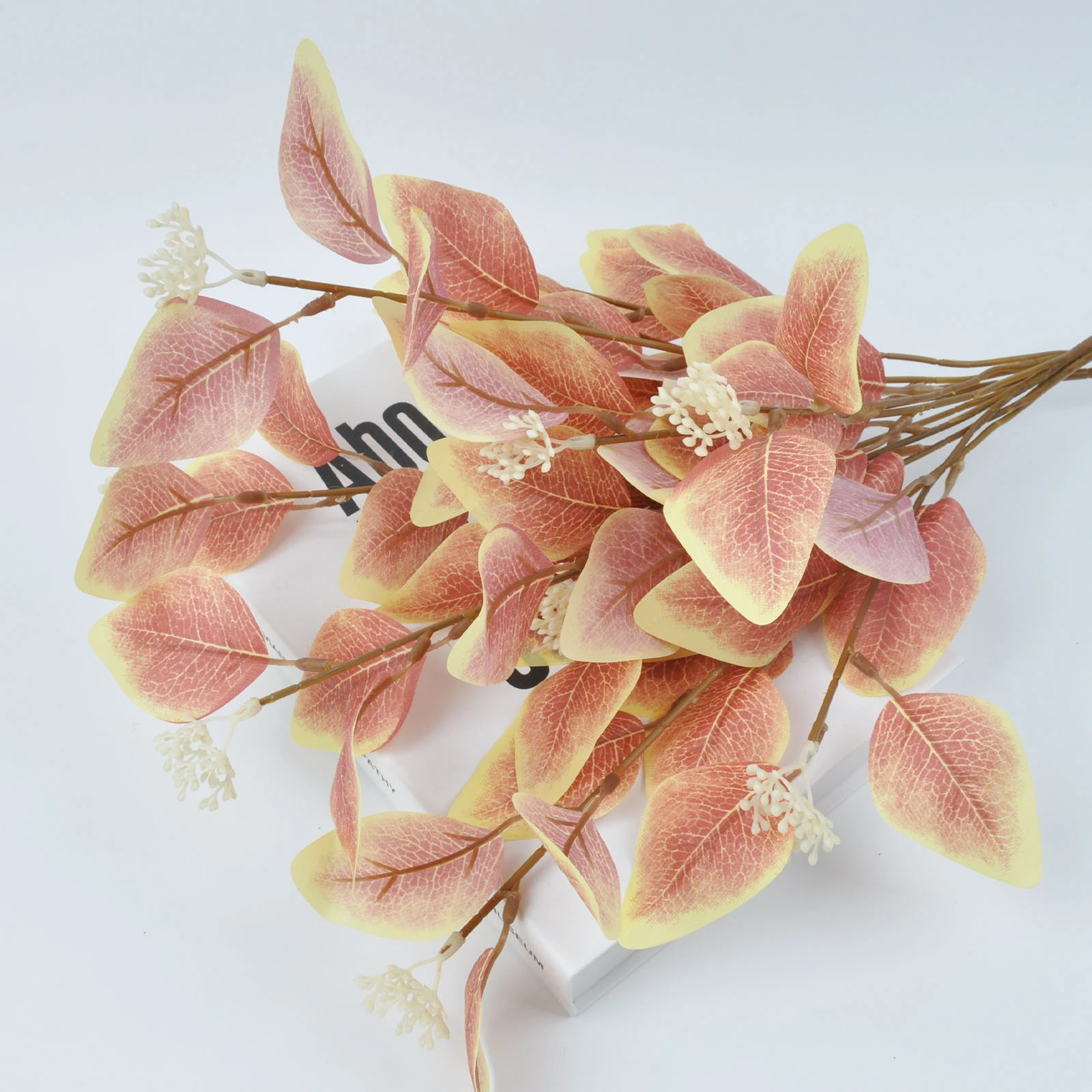 Close-up of blush colored artificial eucalyptus spray
