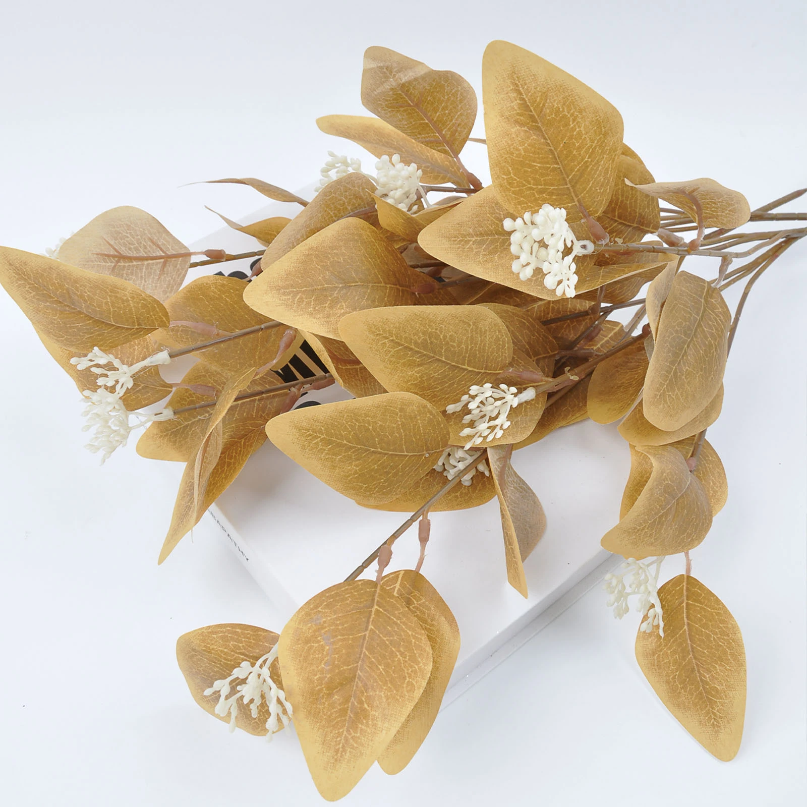 Close-up of yellow colored artificial eucalyptus spray