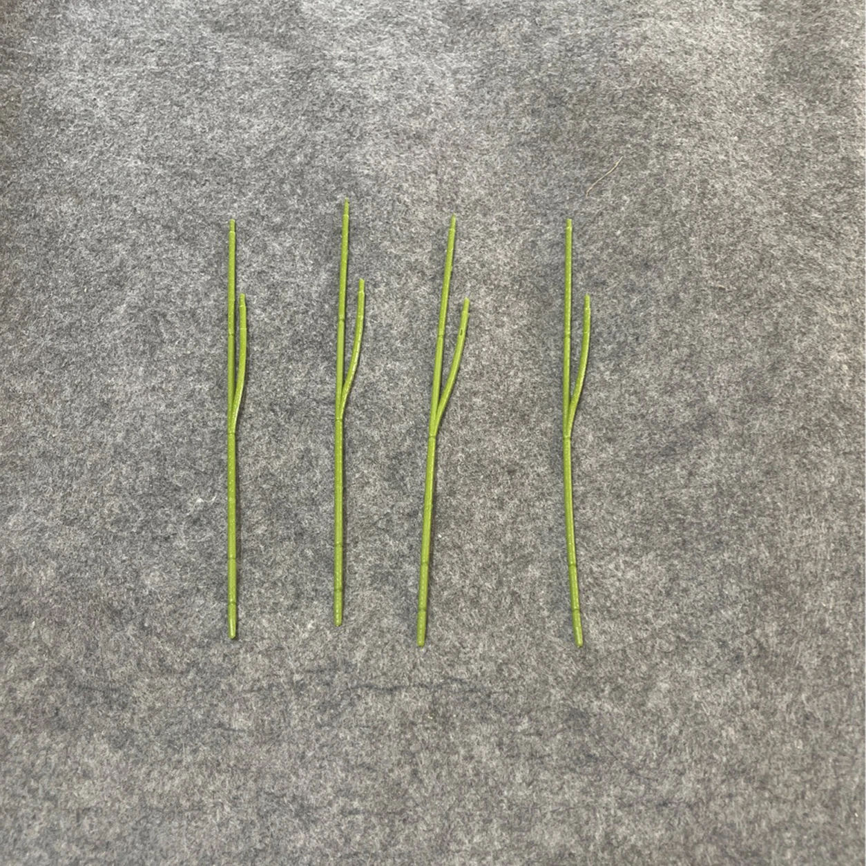 Group display of green Forked Artificial Flower Stem