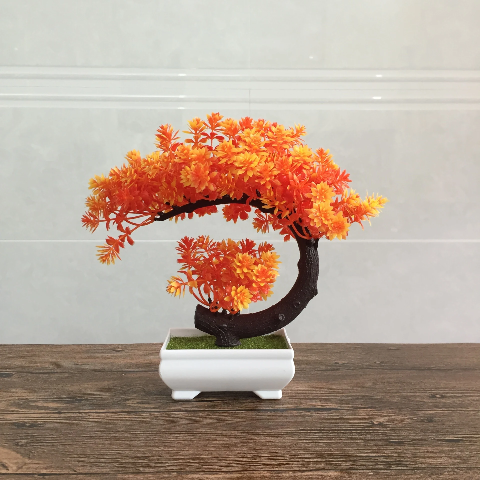 Orange potted artificial conifer bonsai tree