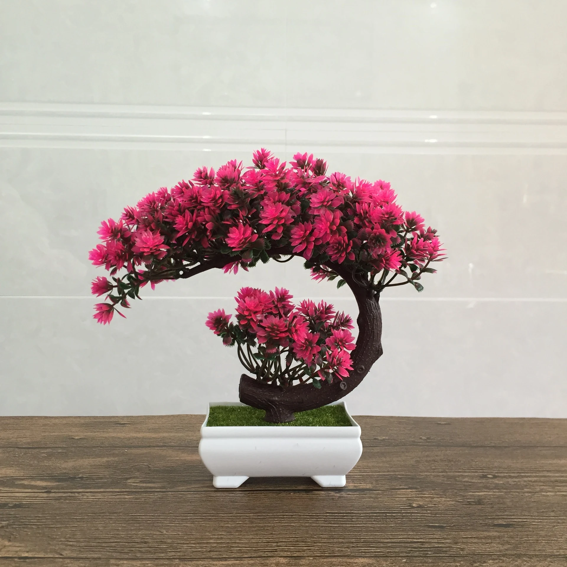 Pink potted artificial conifer bonsai tree