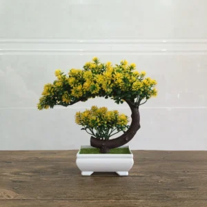 Yellow potted artificial conifer bonsai tree