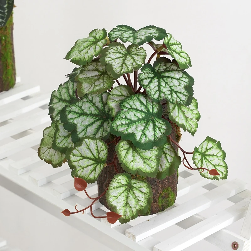 Green potted artificial coral bells plant