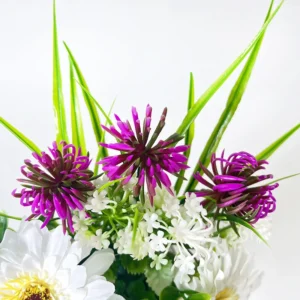 Close-up of potted artificial daisy mixed flower arrangement
