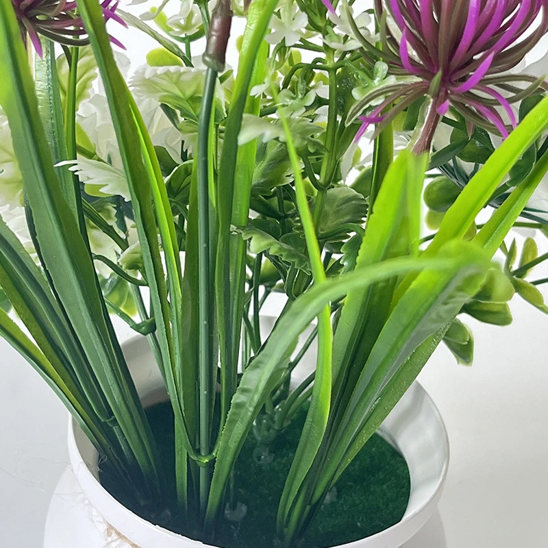 Close-up of potted artificial daisy mixed flower arrangement