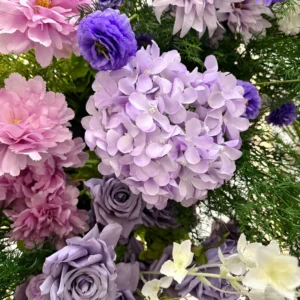 Close-up of purple hydrangea rose wedding flower arch