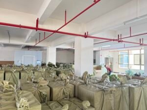 Cartons of wholesale artificial flowers packed and palletized for export from a China factory