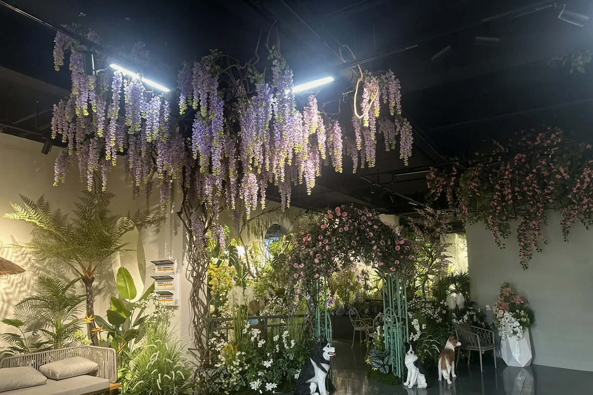 Purple artificial wisteria and greenery arranged in a large commercial interior display