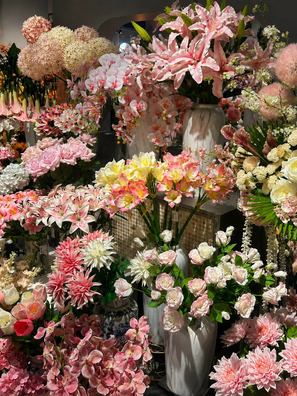 Pink and white blooms from PJTL's Artificial Flowers collection, arranged in showroom vases.