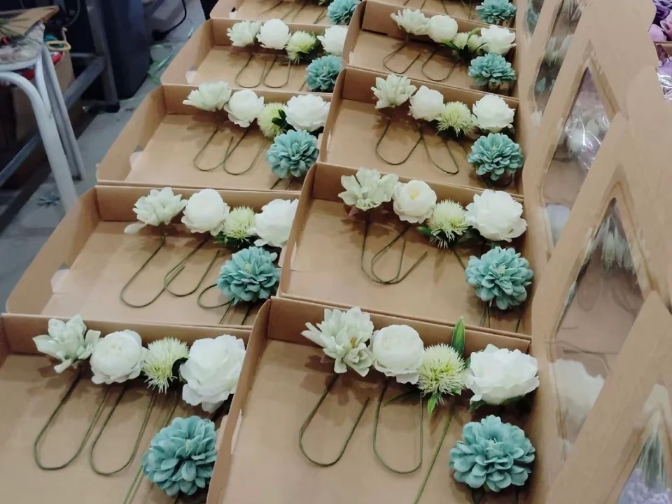 White and Green Artificial Floral Pieces in Boxes